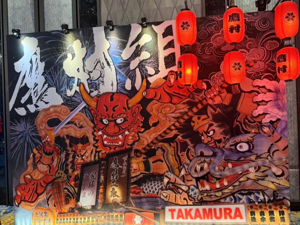 台北尾牙佈置：日式慶典主題背板，結合動漫風格繪圖與紅色燈籠裝飾，營造熱血奔放的活動氛圍。